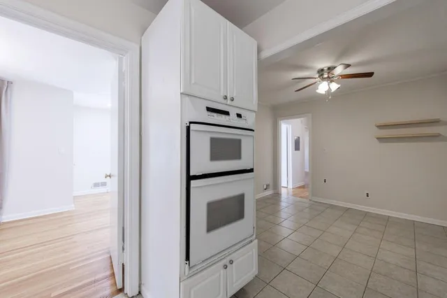 a kitchen with cabinets and stainless steel appliances