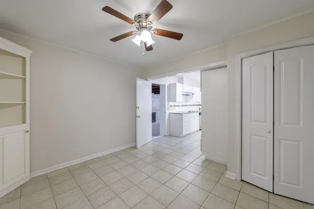 a view of a kitchen with wooden cabinet and a ceiling fan