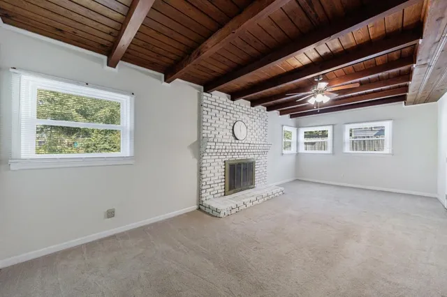 a view of empty room with a fireplace