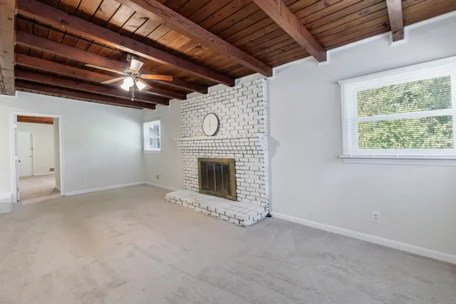 a view of an empty room with a fireplace