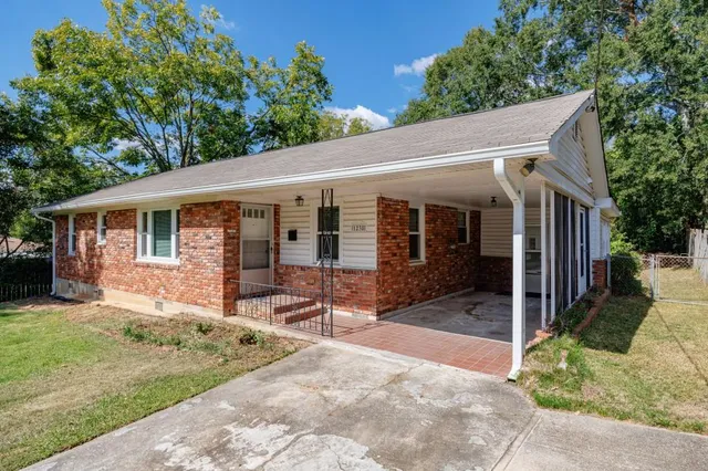 a backyard of a house with yard and outdoor seating