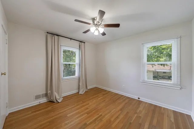 wooden floor in an empty room with a window