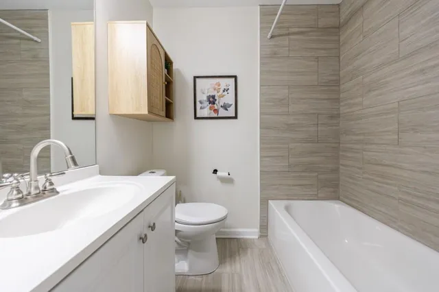 a bathroom with a sink a toilet and bathtub