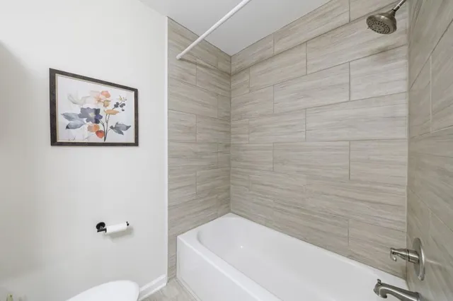 a bathroom with a shower and a toilet