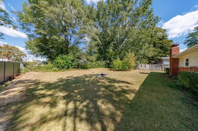 a view of a yard with plants and a trees