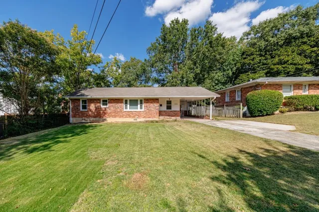 a front view of a house with yard patio and green space