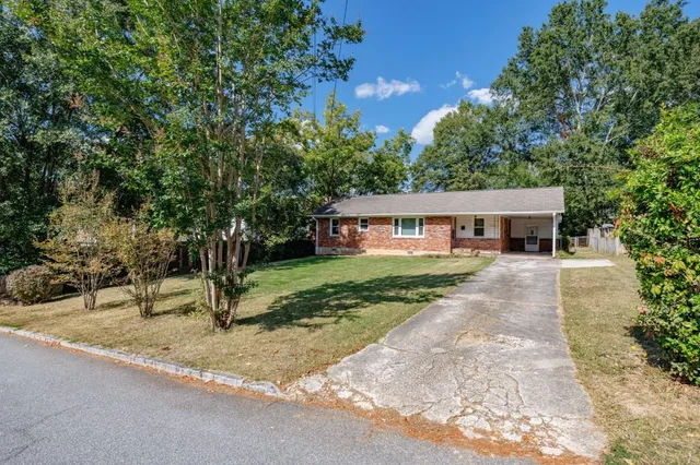 a front view of a house with a garden
