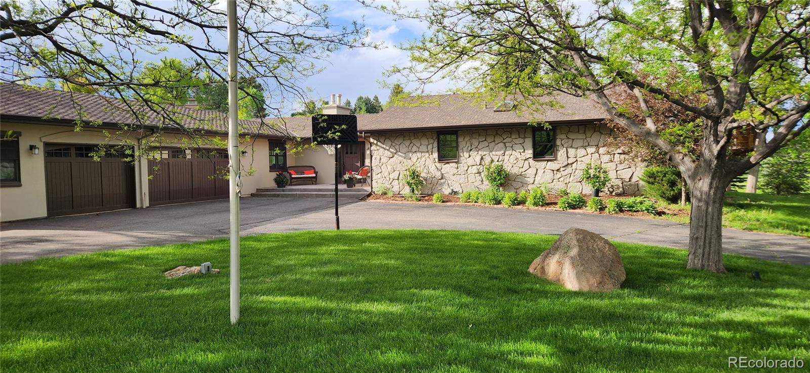 a view of a chair and table in backyard of the house