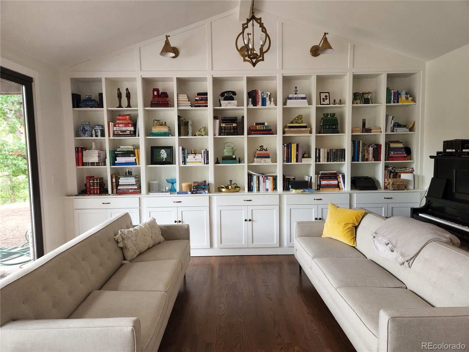 6650 Crestbrook Drive Morrison, CO 80465 - Photo 11 of 38 a living room with furniture fireplace and chandelier