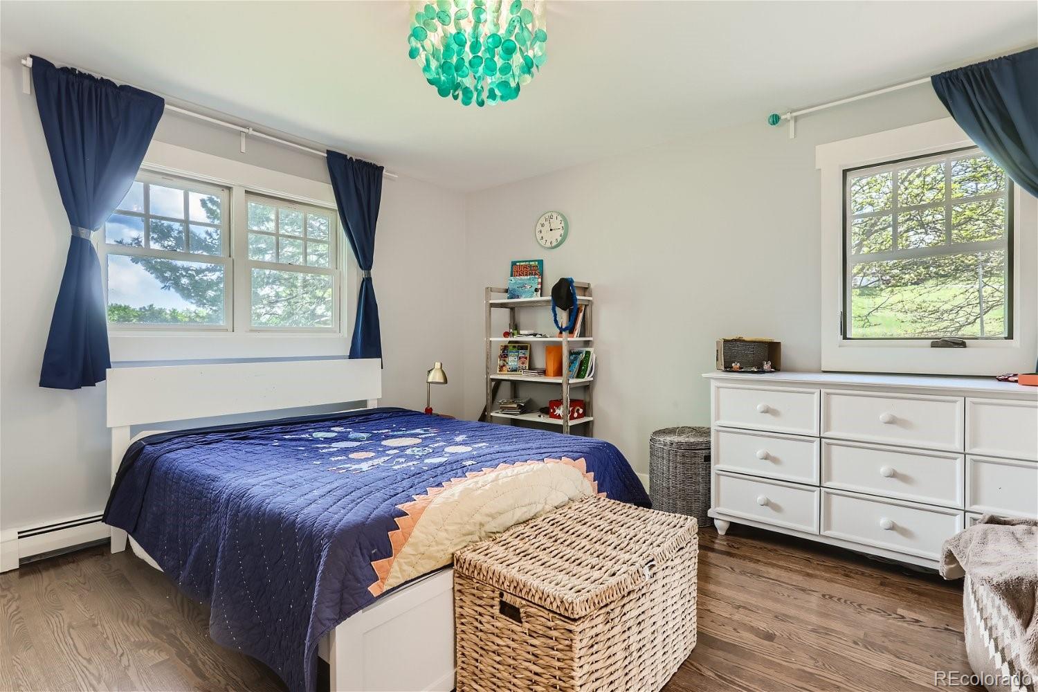 6650 Crestbrook Drive Morrison, CO 80465 - Photo 15 of 38 a bedroom with a bed and a window dresser