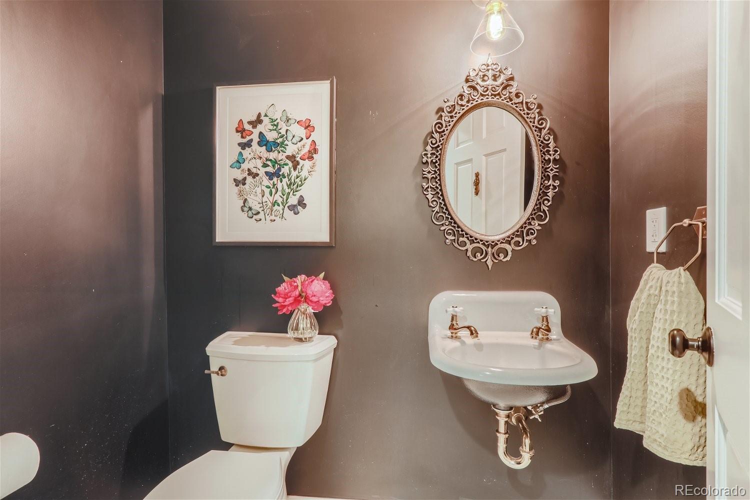 6650 Crestbrook Drive Morrison, CO 80465 - Photo 18 of 38 a bathroom with a toilet sink and mirror