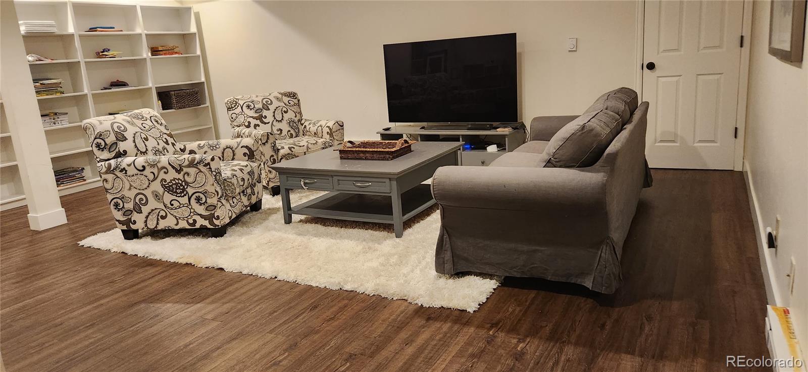 6650 Crestbrook Drive Morrison, CO 80465 - Photo 19 of 38 a living room with furniture and a flat screen tv