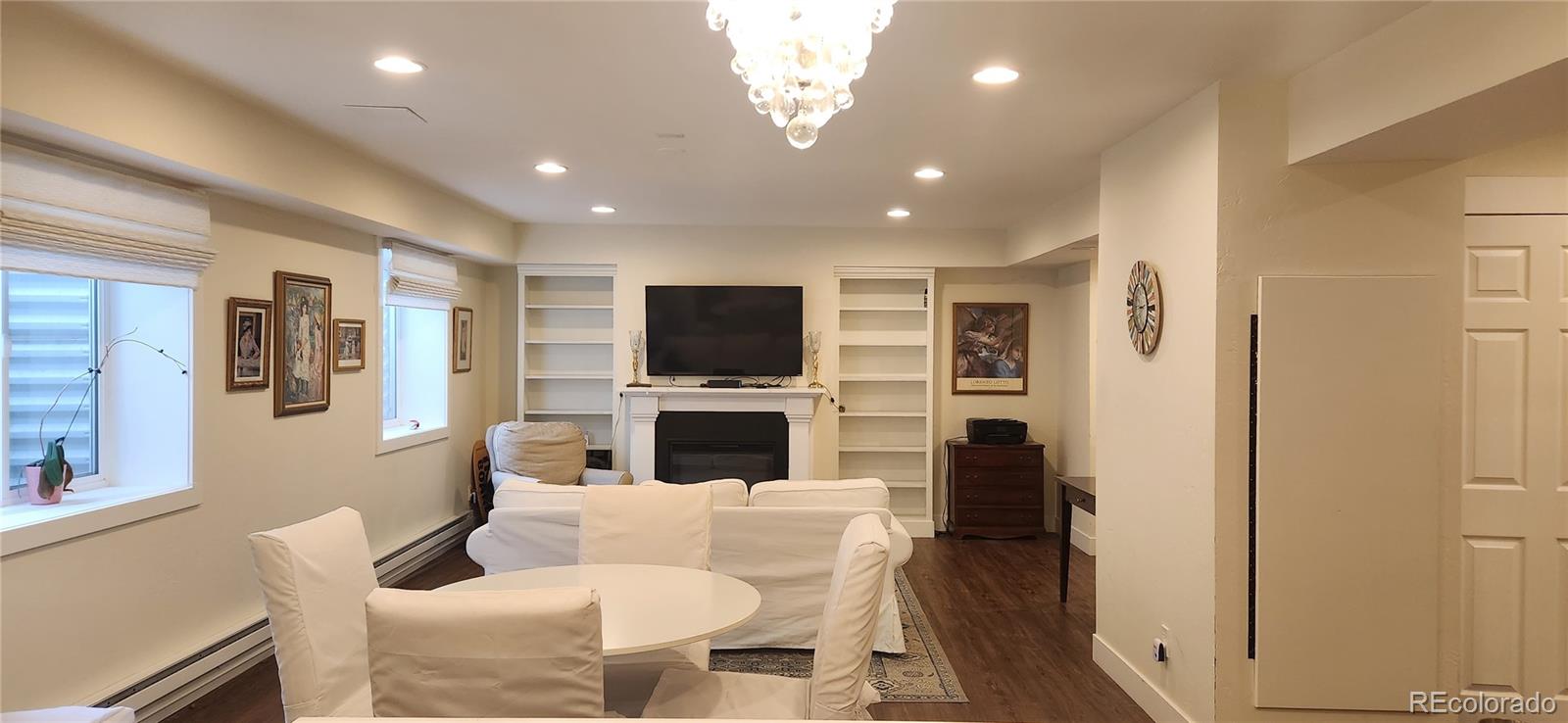 6650 Crestbrook Drive Morrison, CO 80465 - Photo 20 of 38 a living room with furniture and a flat screen tv