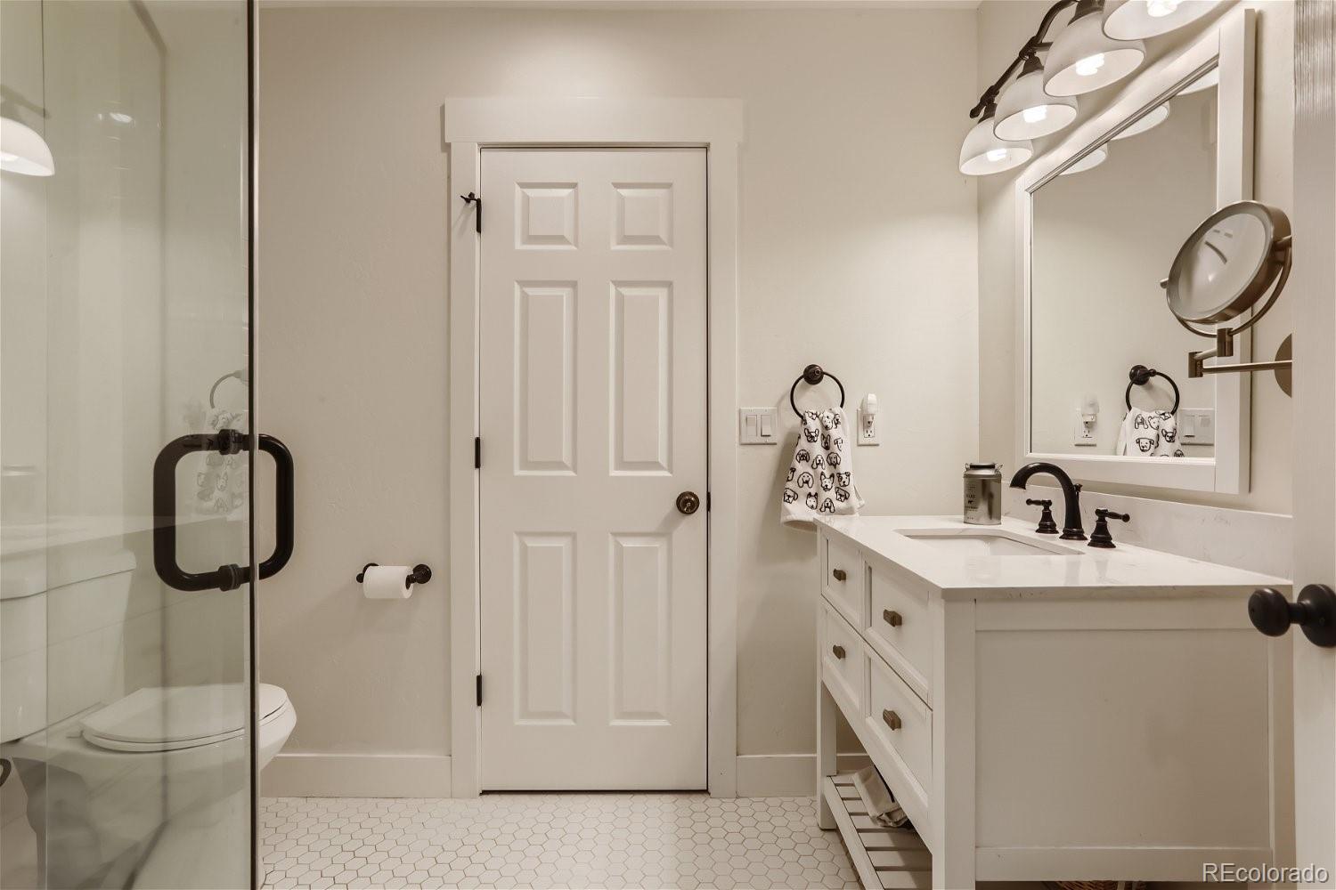 6650 Crestbrook Drive Morrison, CO 80465 - Photo 23 of 38 a bathroom with a sink and a mirror