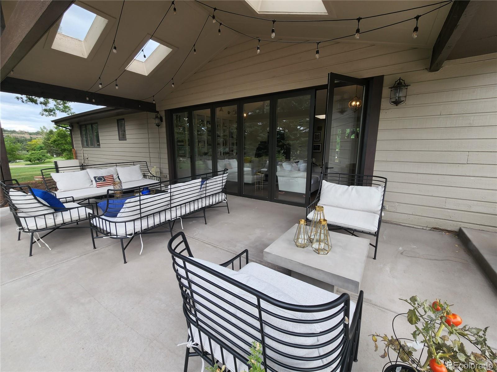 6650 Crestbrook Drive Morrison, CO 80465 - Photo 26 of 38 a outdoor space with patio the couches and a fireplace