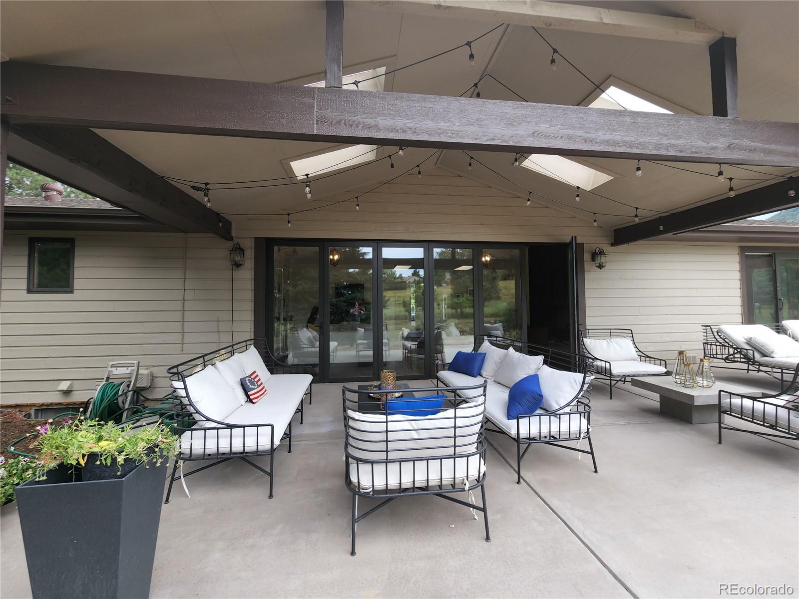6650 Crestbrook Drive Morrison, CO 80465 - Photo 27 of 38 a building outdoor space with patio furniture and potted plants