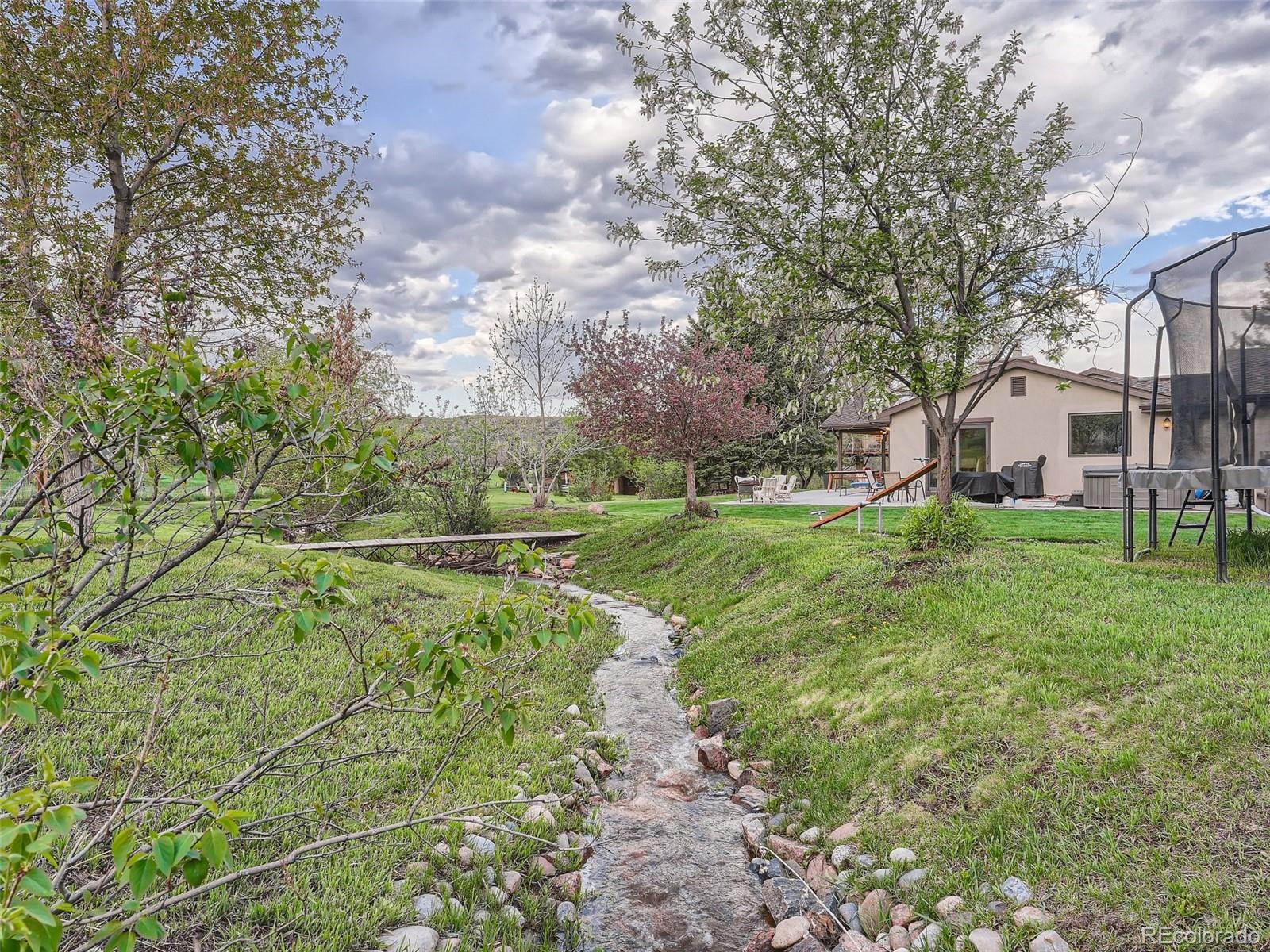 6650 Crestbrook Drive Morrison, CO 80465 - Photo 28 of 38 a view of a garden with large trees