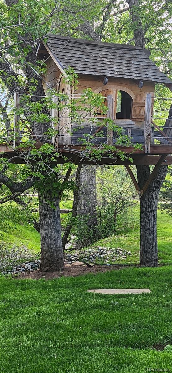 6650 Crestbrook Drive Morrison, CO 80465 - Photo 29 of 38 a view of a yard with plants and a fountain