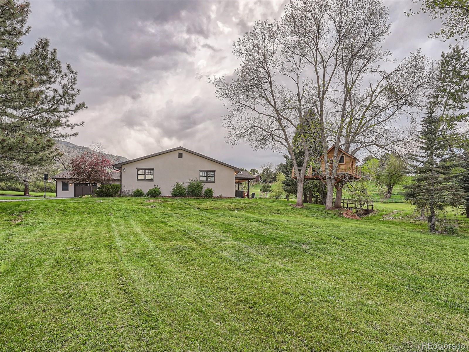 6650 Crestbrook Drive Morrison, CO 80465 - Photo 34 of 38 a front view of a house with garden