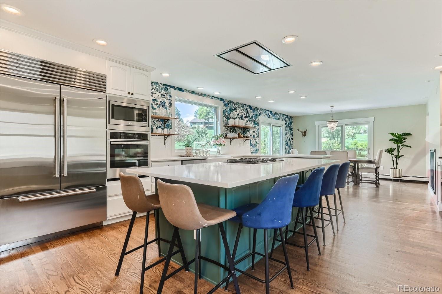 6650 Crestbrook Drive Morrison, CO 80465 - Photo 6 of 38 a dining area with a table chairs and a counter top space