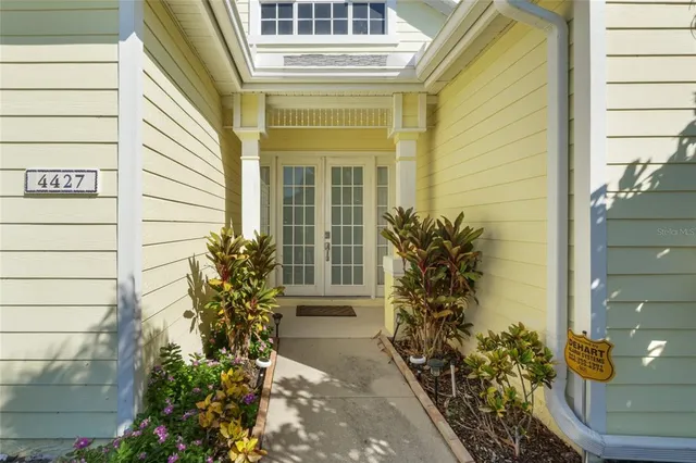 a view of a room with wooden floor and windows