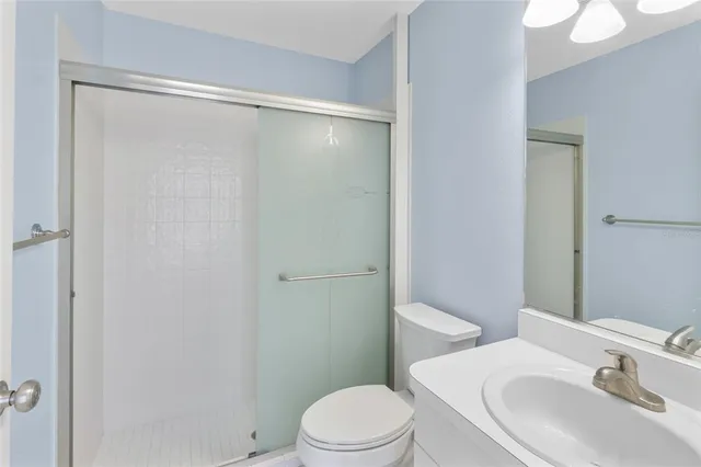 an aerial view of a house with garden space and street view