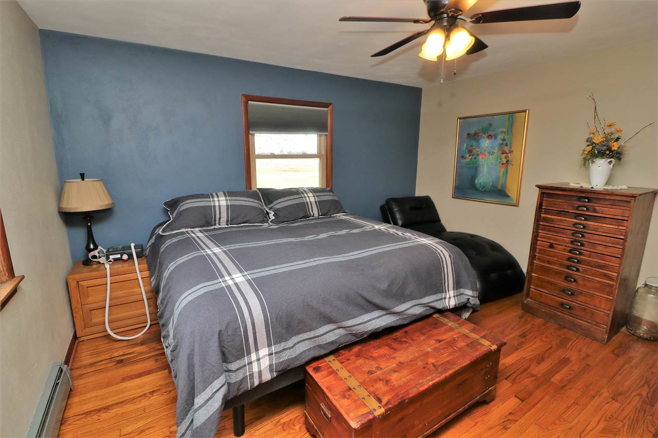 16127 Edwardsville Road Pecatonica, IL 61063 - Photo 11 of 26 a bedroom with a bed and window