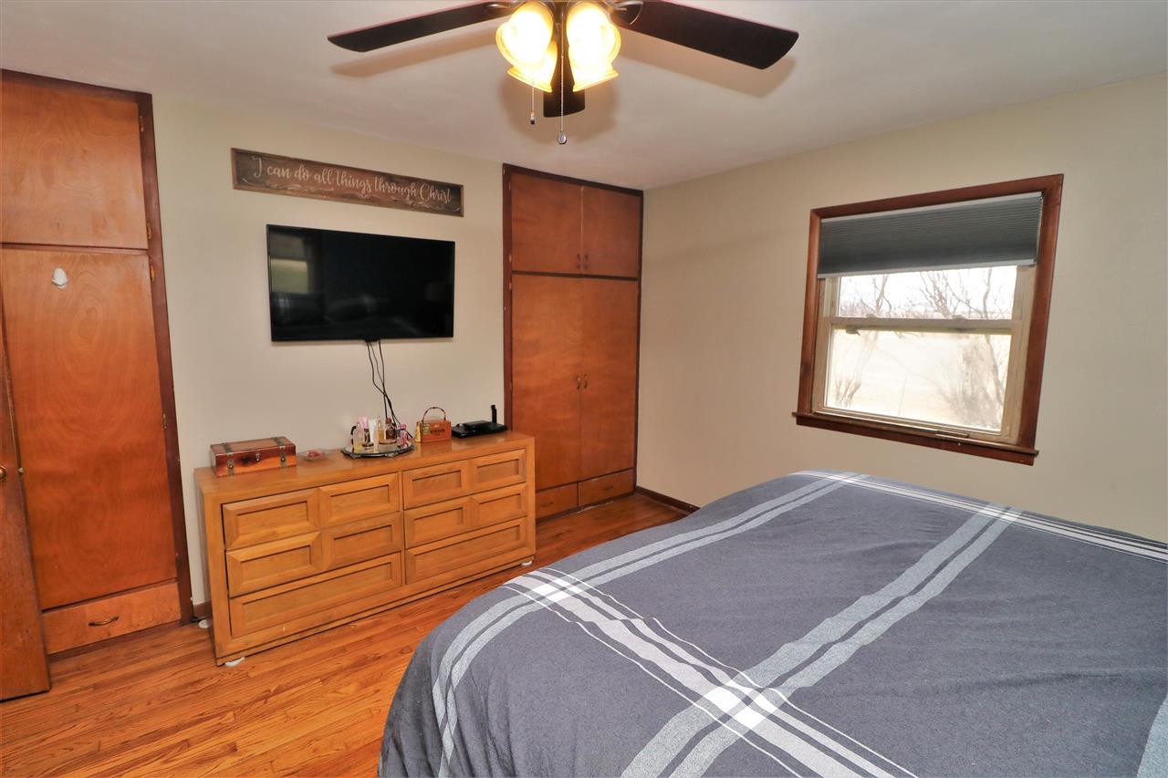16127 Edwardsville Road Pecatonica, IL 61063 - Photo 12 of 26 a bedroom with a bed and a flat screen tv