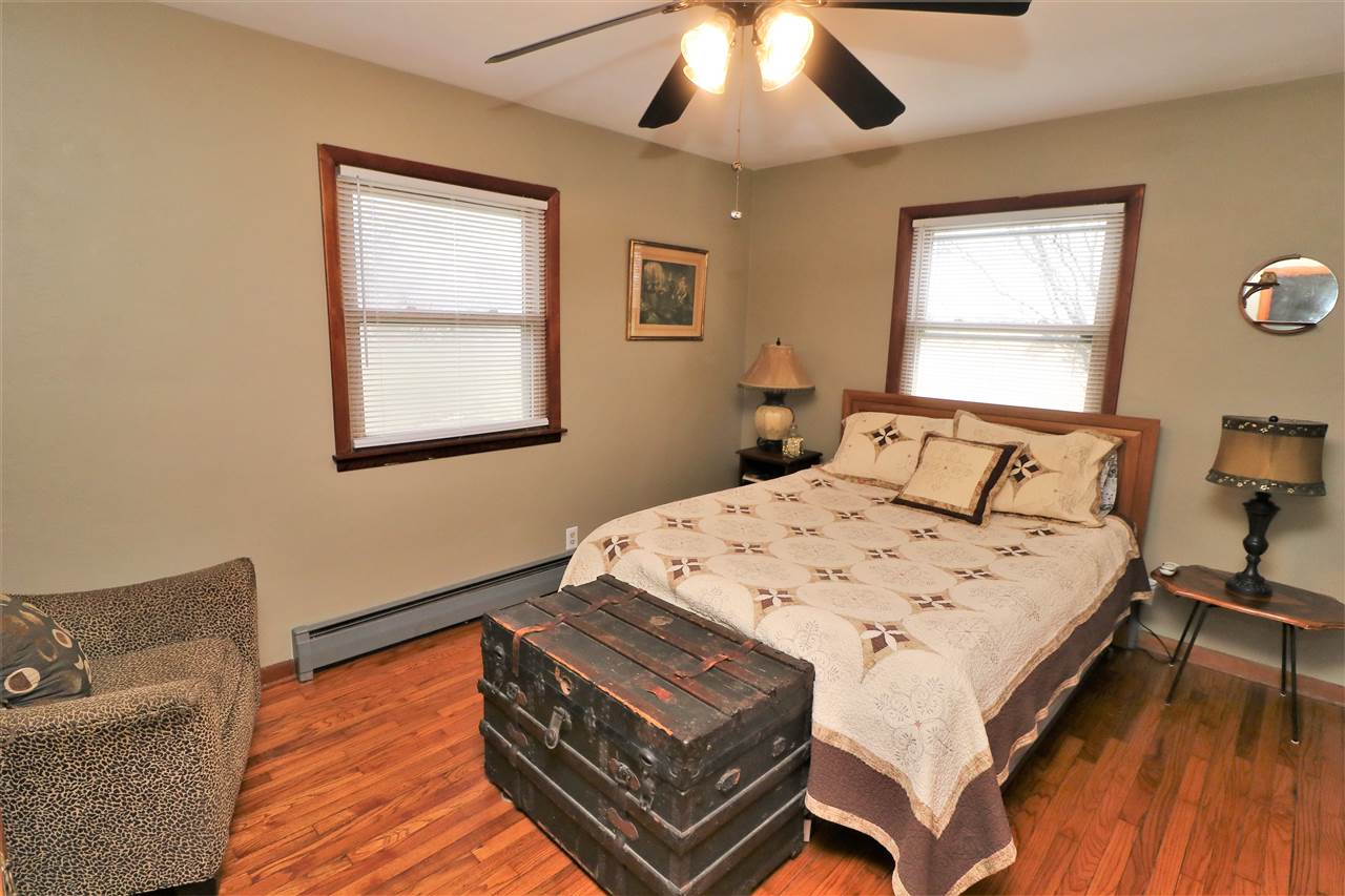 16127 Edwardsville Road Pecatonica, IL 61063 - Photo 13 of 26 a bed sitting in a bedroom next to a window