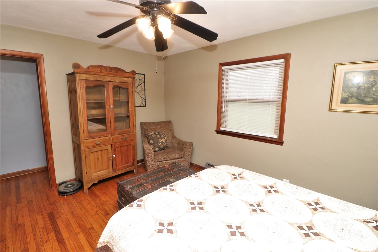 16127 Edwardsville Road Pecatonica, IL 61063 - Photo 16 of 26 a bedroom with bed and wooden floor
