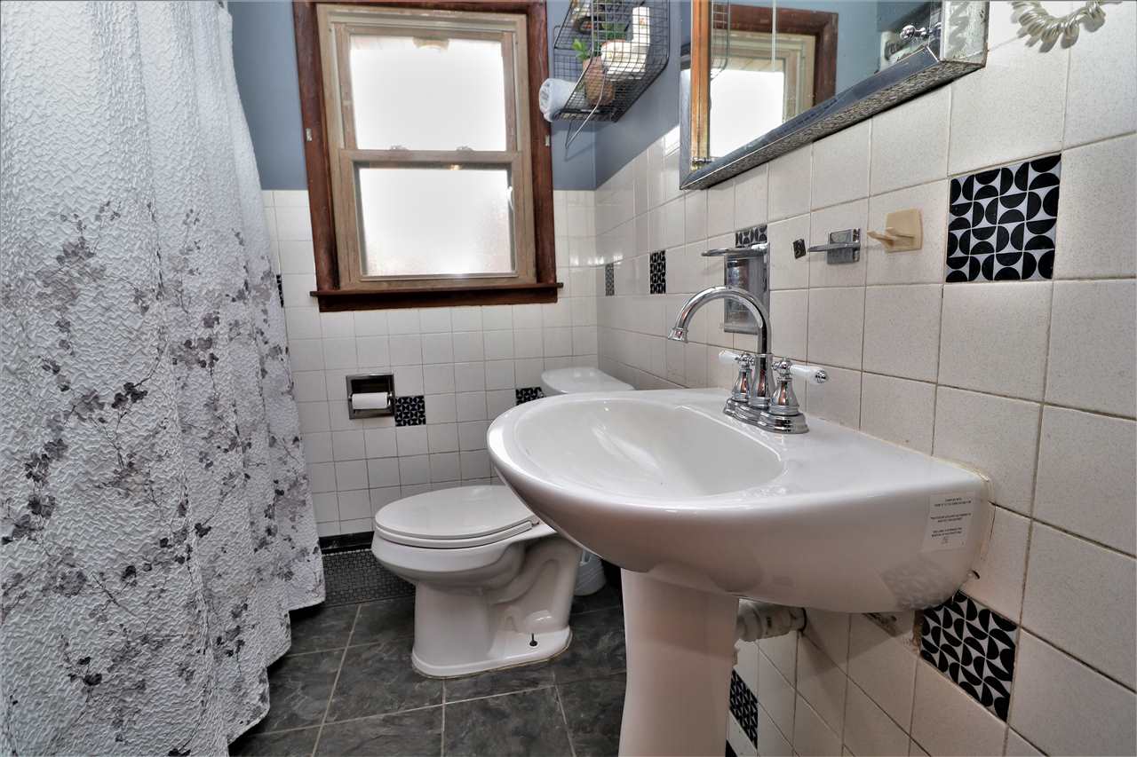 16127 Edwardsville Road Pecatonica, IL 61063 - Photo 20 of 26 a bathroom with a sink toilet and mirror