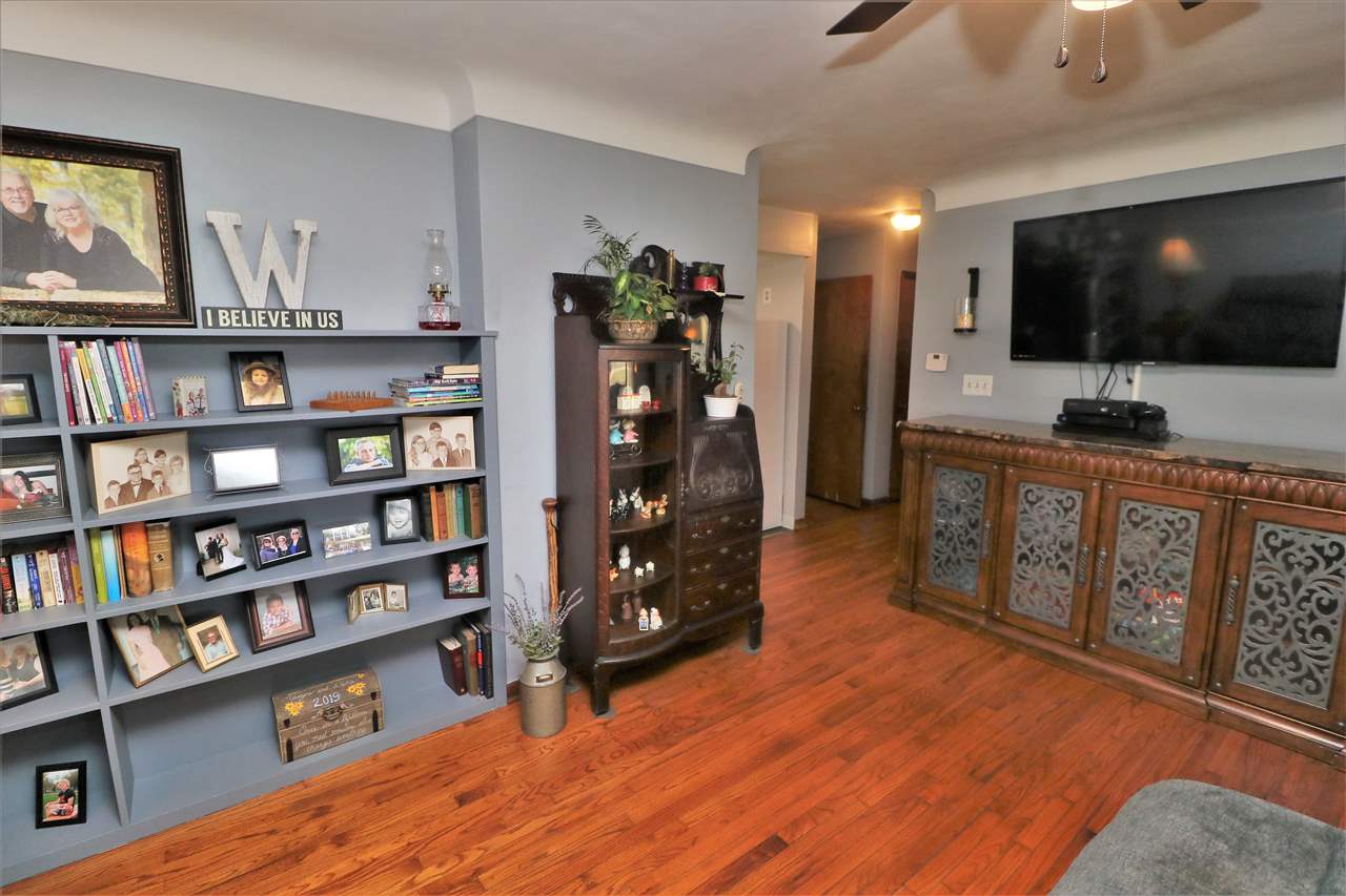 16127 Edwardsville Road Pecatonica, IL 61063 - Photo 5 of 26 a view of a livingroom with furniture and a flat screen tv