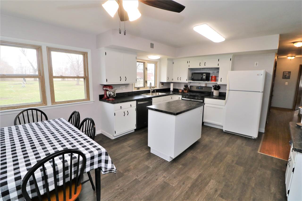 16127 Edwardsville Road Pecatonica, IL 61063 - Photo 6 of 26 a kitchen with sink a refrigerator and cabinets