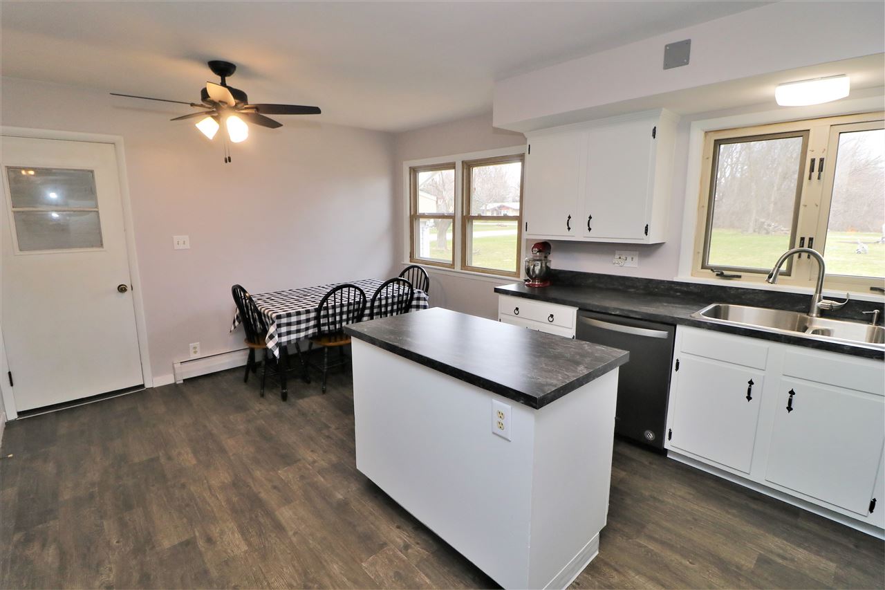 16127 Edwardsville Road Pecatonica, IL 61063 - Photo 7 of 26 a kitchen with granite countertop stainless steel appliances a sink and cabinets