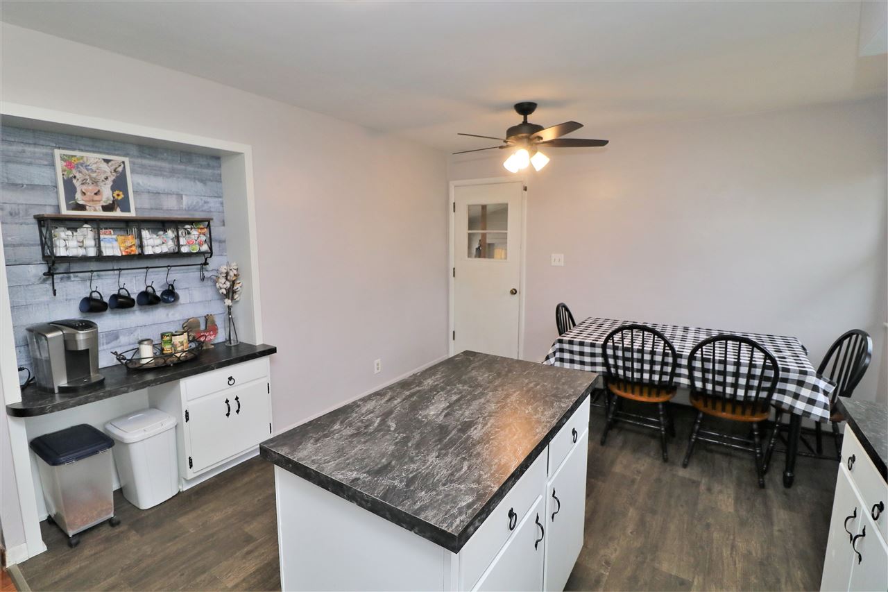 16127 Edwardsville Road Pecatonica, IL 61063 - Photo 8 of 26 a kitchen that has a cabinets and chairs in it