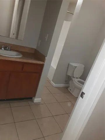 a white toilet sitting next to a bath tub