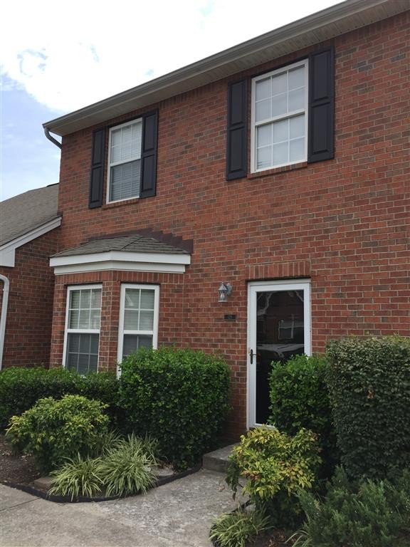 1101 Downs Boulevard, Unit 125 Franklin, TN 37064 - Photo 2 of 8 a front view of a house with a yard