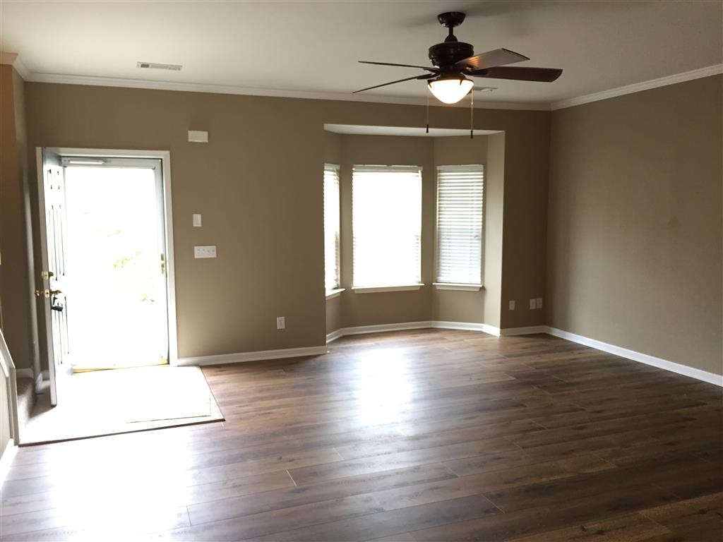 1101 Downs Boulevard, Unit 125 Franklin, TN 37064 - Photo 3 of 8 a view of an empty room with window and wooden floor