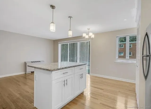 a view of a kitchen counter space and wooden floor