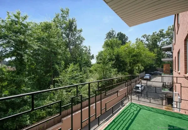 a view of a roof deck with table and chairs potted plants with wooden floor