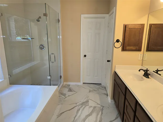 a bathroom with a tub sink and mirror