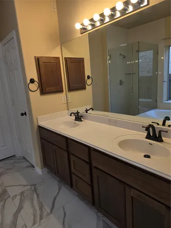 a bathroom with a double vanity sink and mirror