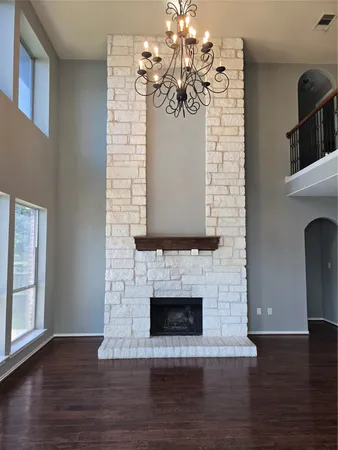 a view of a livingroom with a fireplace and chandelier