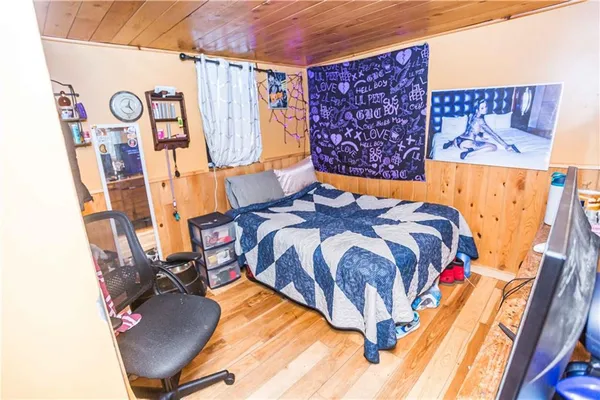 a bed sitting in a bedroom next to a window