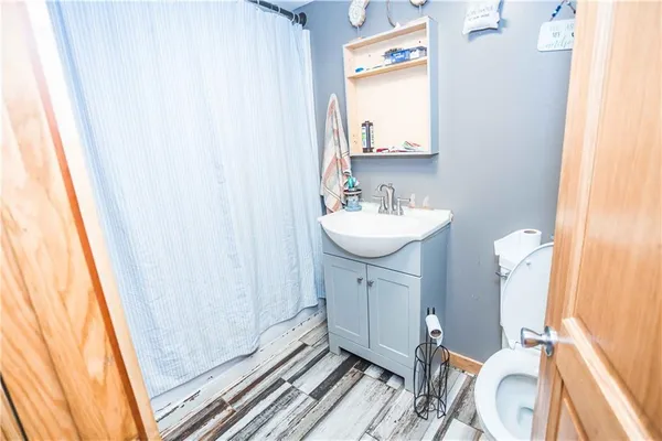 a bathroom with a sink a toilet and a mirror