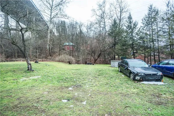 a backyard of a house with barbeque oven fire pit table and chairs