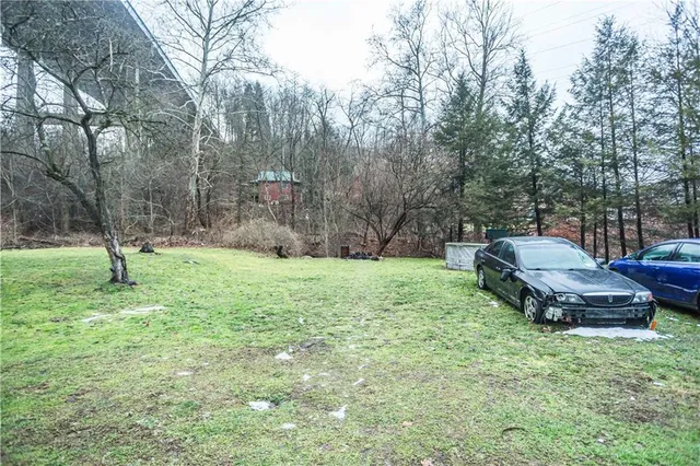 a backyard of a house with barbeque oven fire pit table and chairs