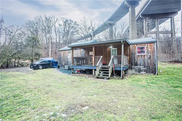a view of a house with a yard and sitting area