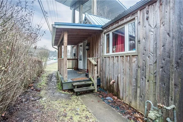 a view of front door of house with stairs