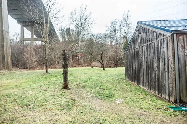 a view of a backyard with wooden fence